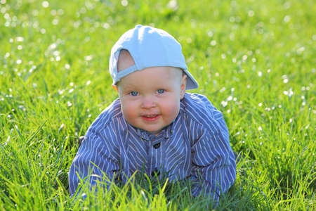 Happy young kid playing in the grassの写真素材