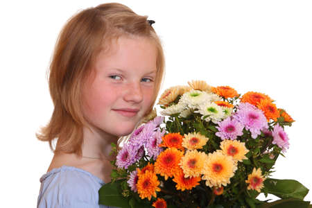 Portrait of a young girl holding a bunch of flowersの写真素材