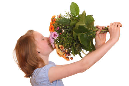 Portrait of a young girl holding a bunch of flowersの写真素材