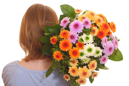 Portrait of a young girl holding a bunch of flowersの写真素材
