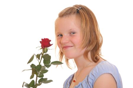 Portrait of a young teenage girl with a red roseの写真素材