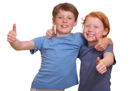 Two happy young kids with thumbs upの写真素材