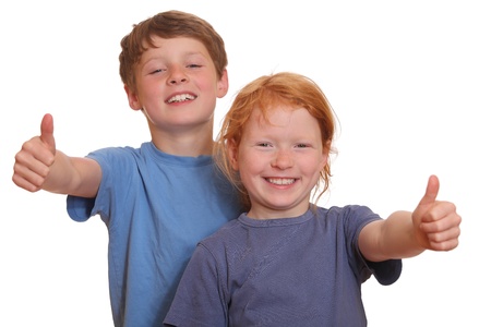 Two happy young kids with thumbs upの写真素材