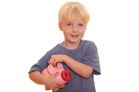 Portrait of a young blond boy holding his piggy bankの写真素材