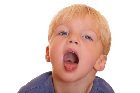 Naughty young boy sticks out his tongue の写真素材