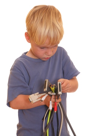Young boy with lots of different computer cablesの写真素材