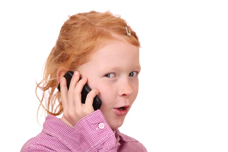 Happy young girl with cell phone on white backgroundの写真素材