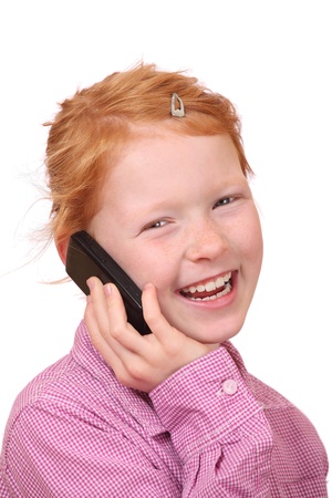 Happy young girl with cell phone on white backgroundの写真素材