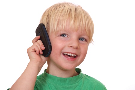 Portrait of a young boy with his new cell phoneの写真素材