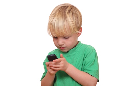 Portrait of a young boy playing with his new cell phoneの写真素材
