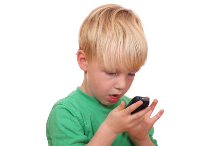 Portrait of a young boy playing with his new cell phoneの写真素材