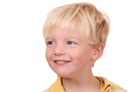 Portrait of a smiling young boy on white backgroundの写真素材