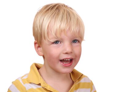 Portrait of a laughing young boy on white backgroundの写真素材