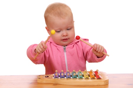 Portrait of a young girl playing a toy xylophoneの写真素材