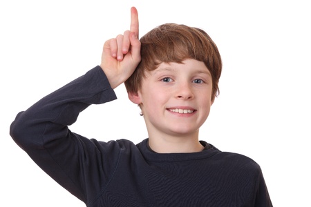 Portrait of a smart boy pointing upwardeの写真素材