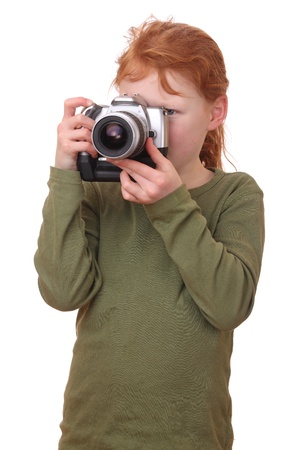 Portrait on a young girl with camera isolated on white backgroundの写真素材