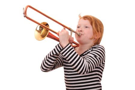 Young girl playing a trombone on white backgroundの写真素材