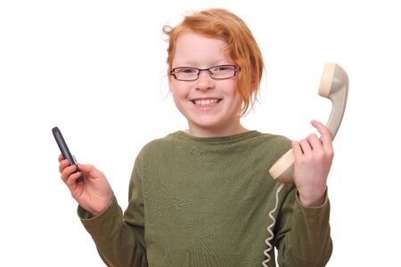 Young girl with cell phone and old phoneの写真素材