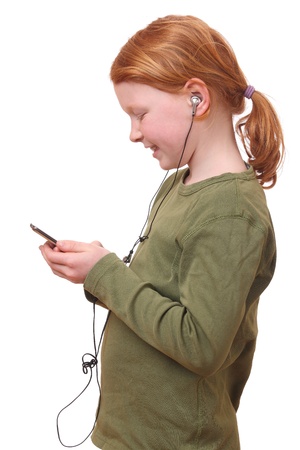 Young girl listening to music on white backgroundの写真素材