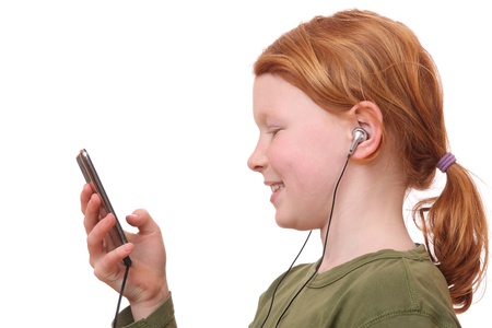Young girl listening to music on white backgroundの写真素材