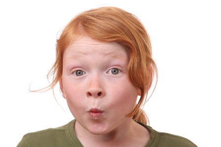 Young girl with eyes wide open on white backgroundの写真素材