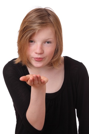 Young girl blowing a kiss on white backgroundの写真素材