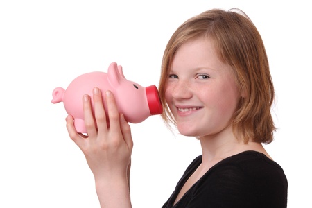 Young girl with piggy bank on white backgroundの写真素材