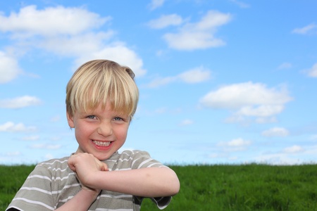 Happy young boy in a meadowの写真素材