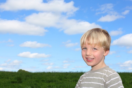 Happy young boy in a meadowの写真素材