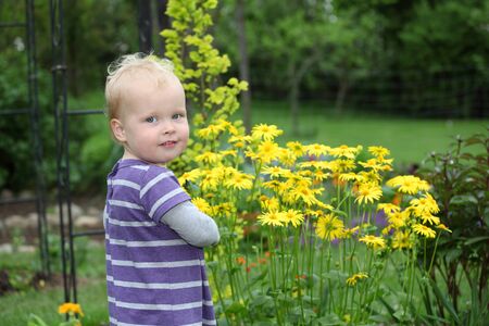Portrait of a happy toddler in the gardenの写真素材