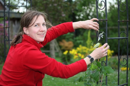 A young woman works in the gardenの写真素材