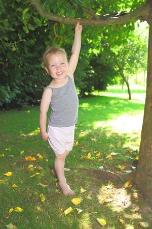 Happy toddler playing in the gardenの写真素材