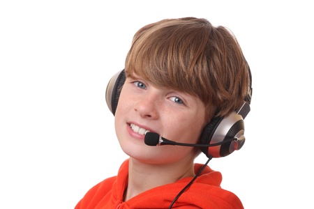 Young boy wearing headphone with microphone on white backgroundの写真素材