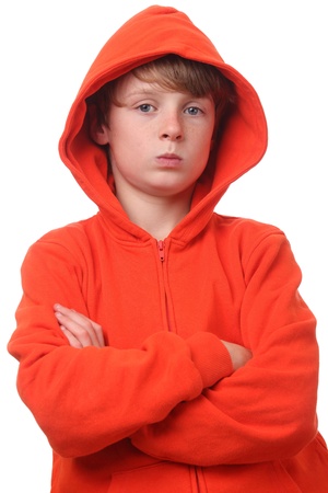 Young boy wearing an orange hoodie on white backgroundの写真素材