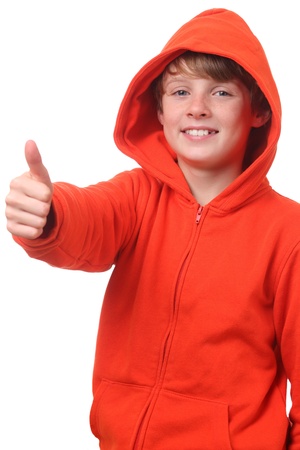 Young boy wearing a hoodie shows thumbs up on white backgroundの写真素材