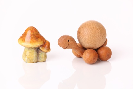 Wooden turtle and mushroom on white backgroundの写真素材