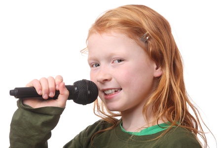 Young red haired girl with microphone on white backgroundの写真素材