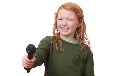 Young red haired girl with microphone on white backgroundの写真素材