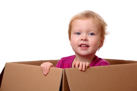 Portrait of a happy young toddler sitting in a boxの写真素材