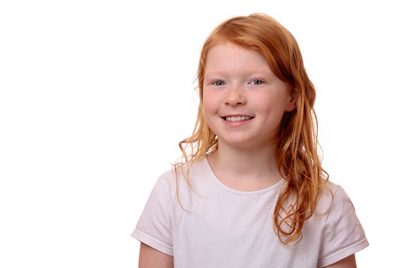 Portrait of a young red haired girl on white backgroundの写真素材