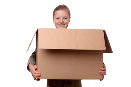 Portrait of a happy young girl carrying a large box