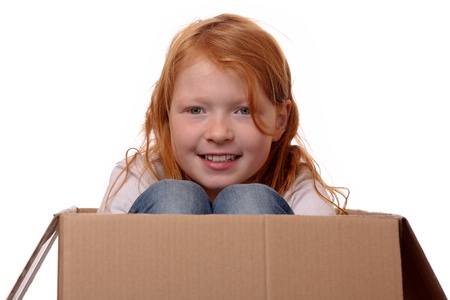 Portrait of a young girl sitting in a boxの写真素材