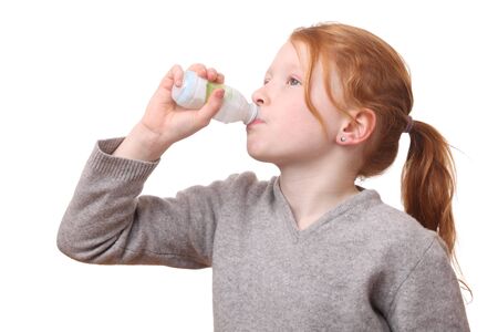 Portrait of a young drinking girl on white backgroundの写真素材