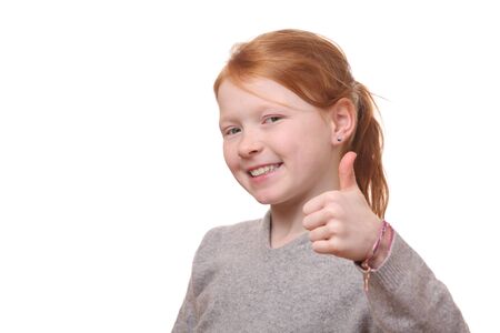 Portrait of a successful girl with thumbs up on white backgroundの写真素材