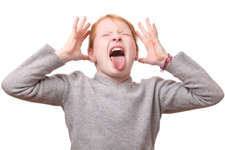 Portrait of a screaming young girl on white backgroundの写真素材