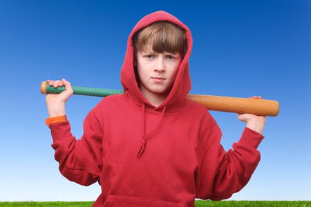 Young boy with a baseball bat outdoorsの写真素材