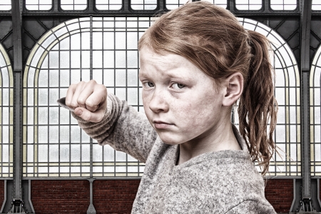 Young girl throws a punchの写真素材