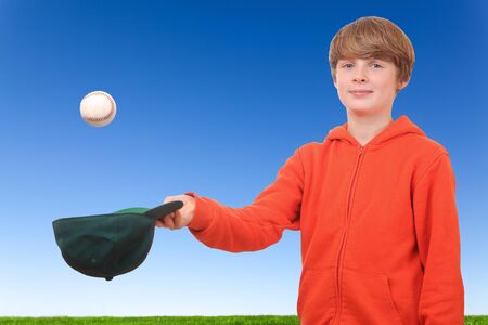 Young boy tries to catch a baseballの写真素材
