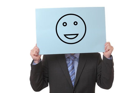 Businessman holding a paper with a positive smiley on white backgroundの写真素材