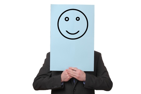 Businessman holding a paper with a positive smiley on white backgroundの写真素材